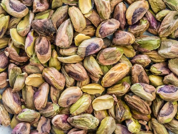 istock Pile of peeled shelled bare pistachio nuts 1857618296