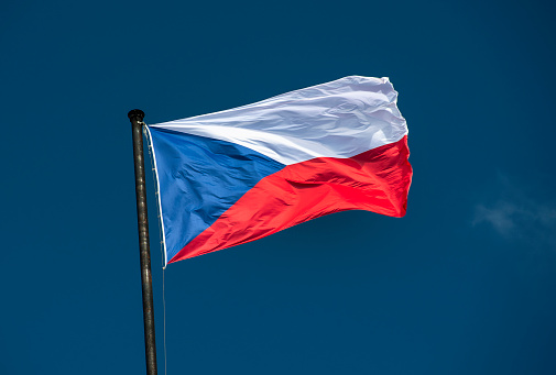 Czech national flag flies over the historic buildings on the Vltava River in Prague Czech Republic Czechia