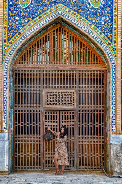 istock Lady posing in the Ulugh Bek Madrassah, Ragistan Square, Samarkand 1857640220