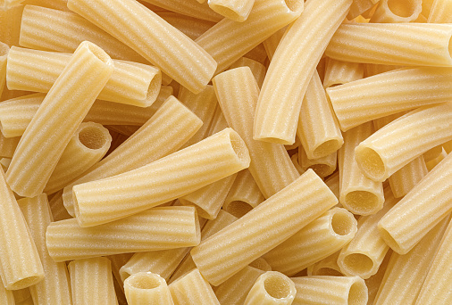 Group of Tortiglioni, traditional Italian pasta, abstract food background