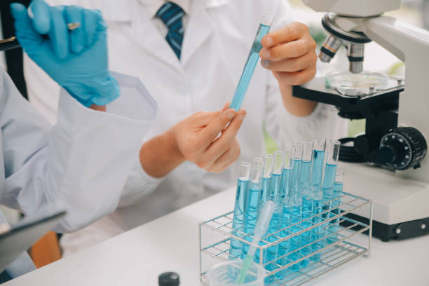 istock Scientist or medical in lab coat working in biotechnological laboratory, Microscope equipment for research with mixing reagents in glass flask in clinical laboratory. 1857725243