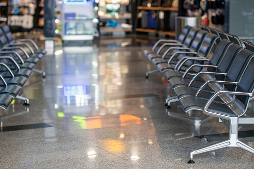 empty chairs and shop lights behind them at Moscow airport
