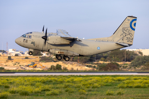 Luqa, Malta - December 13, 2023: Greek (Hellenic) Air Force Alenia C-27J Spartan (REG: 4117) arriving in the setting sun.
