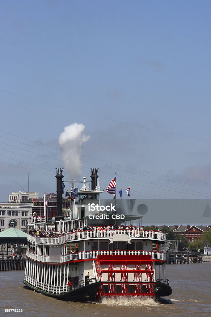 Riverboat on the Mississippi This riverboat is propelled down the Mississippi River in New Orleans by a paddlewheel, carrying tourist and billowing smoke through its smokestacks. In the background to the left is the old Jax Brewery and to the right are the Pontalba Apartments on Jackson Square in the French Quarter. Steamboat Stock Photo