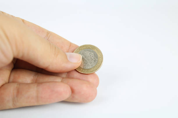istock A hand holding a Turkish coin. 1 Turkish lira. 1857770851