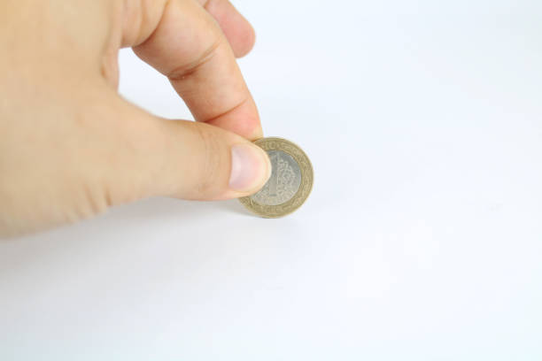 istock A hand puts Turkish coins into the money box. 1857770856