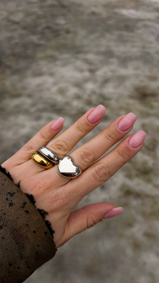 Feminine Fingers Adorned with Rings