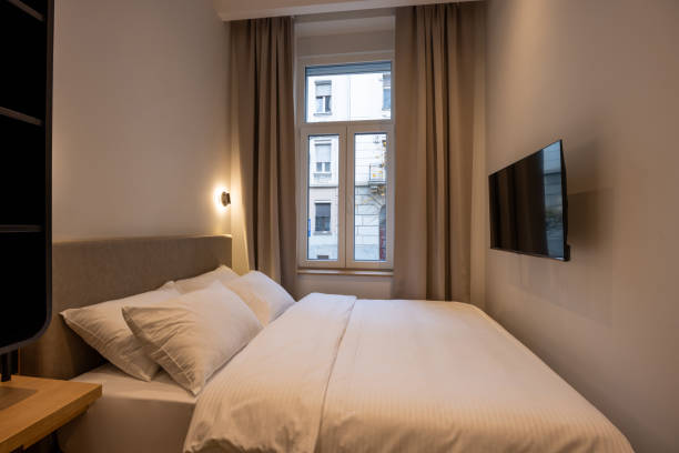 istock Interior of a hotel bedroom with wall mounted tv 1857785455