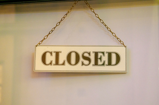 Closed sign hanging in a shop window