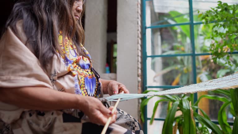 Indigenous senior woman making crafts