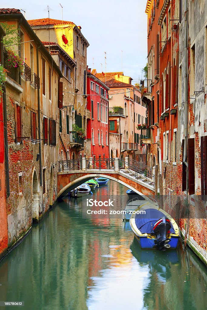 Narrow canal in Venice Narrow canal with boats in Venice, Italy Architecture Stock Photo