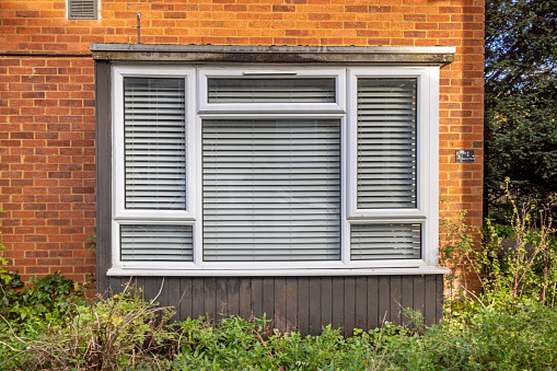 Station Road, Tring, Hertfordshire, England - November 3nd 2023:  Window in a English townhouse with closed blinds