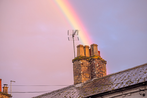 Double rainbow over typical English chimneys after rain on a autumn afternoon. The picture is from the village Tring in Hertfordshire north of London.
