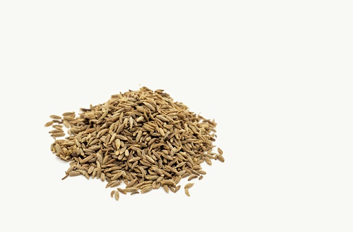 White Cumin or Jeera Seeds Heap Isolated on White Background with Copy Space with Copy Space for Texts Writing.