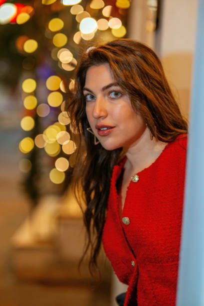 istock Beautiful woman with Christmas lights 1857827072