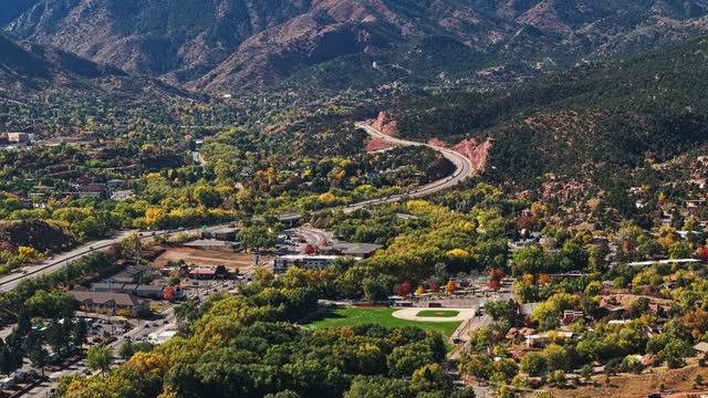 Vibrant yellow autumn trees surround quaint subdivision neighborhood and baseball diamond near Garden of the Gods Colorado