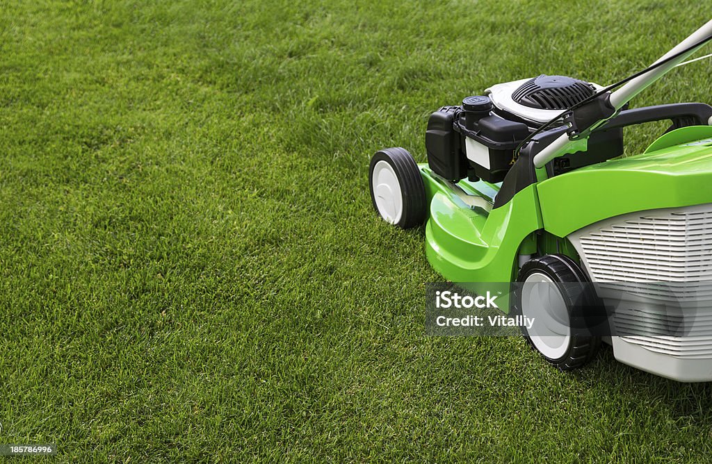 Green lawnmower on the lawn Outdoor shot of green lawnmower Black Color Stock Photo