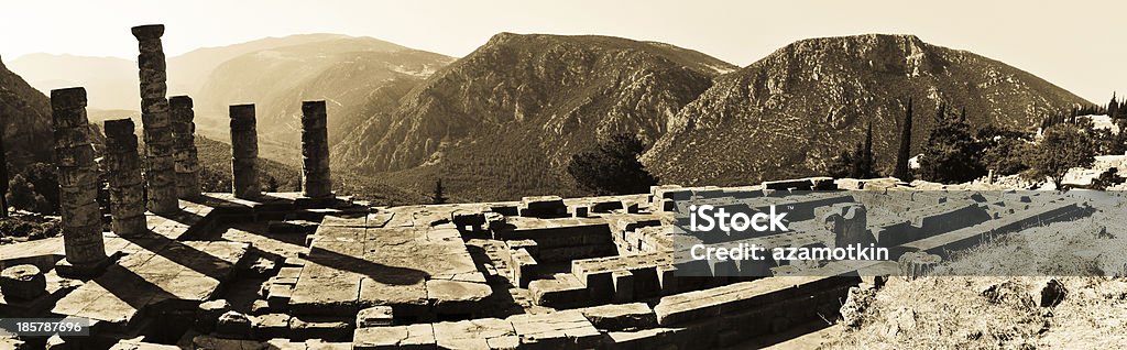 Temple of Apollo at Delphi, Greece. Retro-style photo Temple of Apollo at Delphi, Greece. Panoramic view with mountains Aging Process Stock Photo