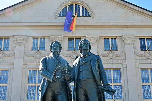 Goethe-Schiller monument in front of the German National Theater on Theaterplatz in Weimar, Thuringia. The world-famous double statue of the two poets was created by Ernst Rietschel in 1857. The Bavarian king donated the materials.