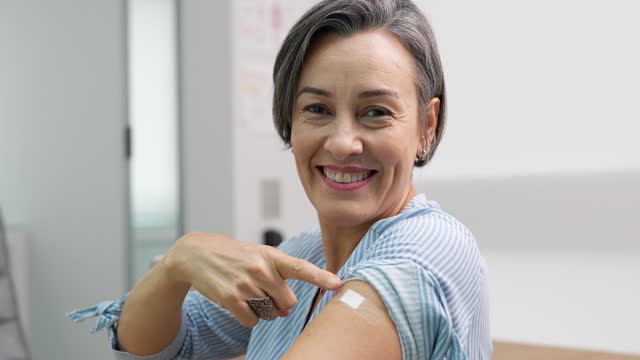 Woman showing vaccinated arm