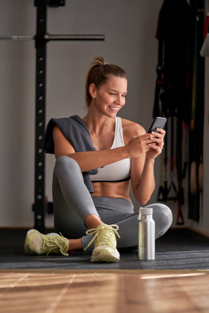istock Sportswoman using cellphone in gym 1857911587