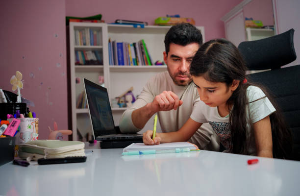 istock Young father explaining homework helping child girl with studies 1857941309