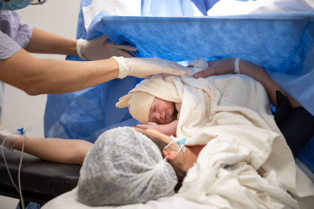 istock Mother and newborn daughter by cesarean section 1857941380