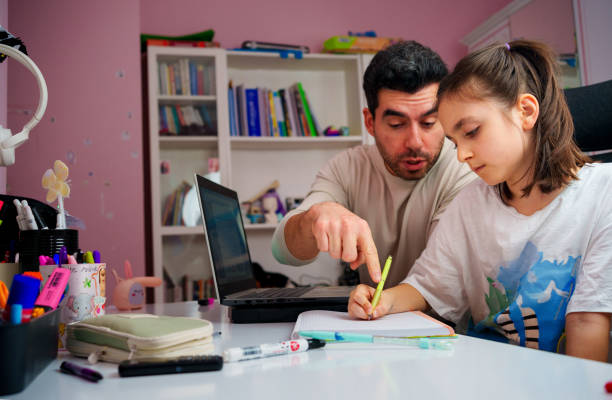 istock Young father explaining homework helping child girl with studies 1857941404