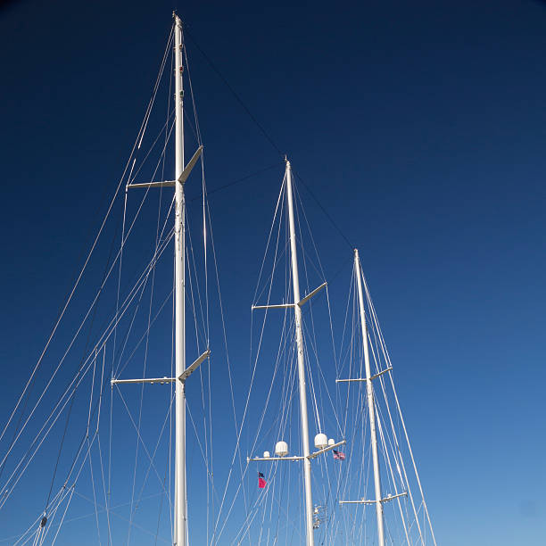 istock White masts of a sailboat & blue sky 185794820