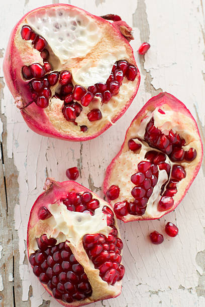 istock Juicy pomegranate and its half with leaves. 185795899
