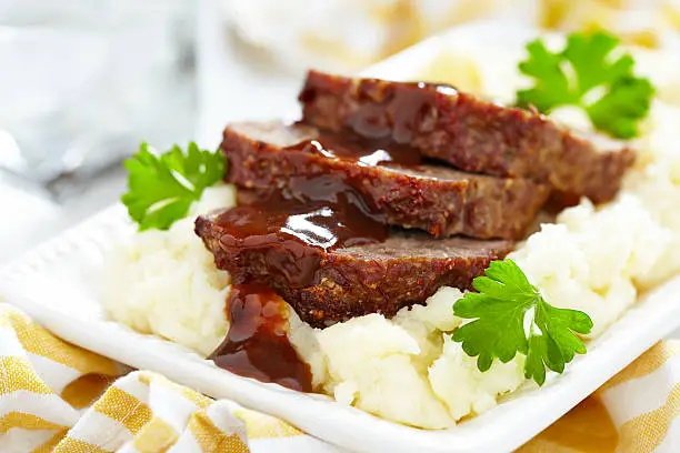 Meatloaf with brown sauce on mashed potato