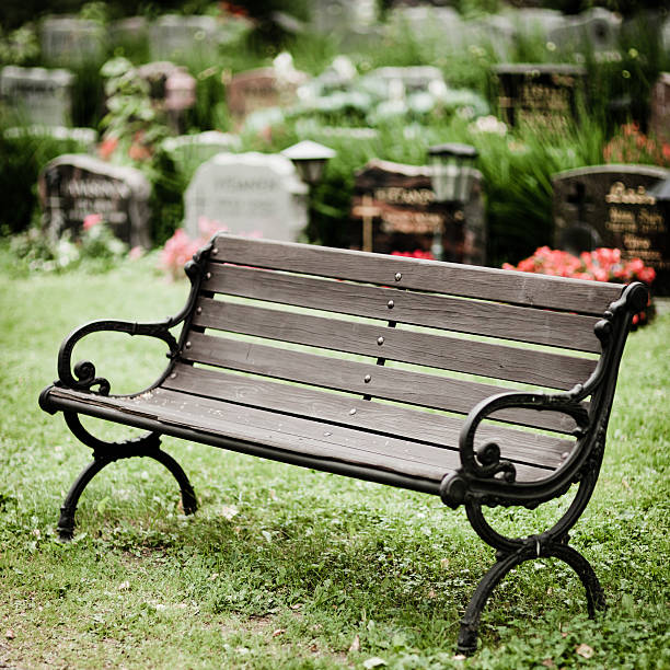 istock Empty old wooden bench in cemetery 185796917