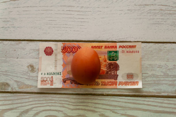 istock Chicken eggs on the background of banknotes 1858014030