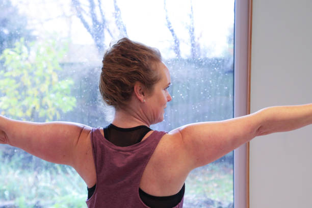 istock Woman doing Tai Chi with arms stretched to sides 1858024696
