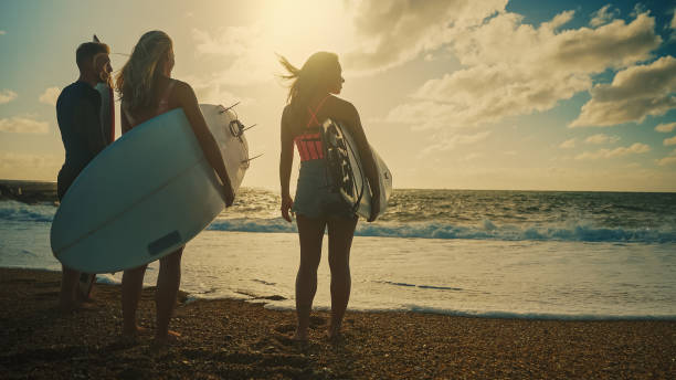 istock Surfers checking out waves from coastline at the beach 1858043455