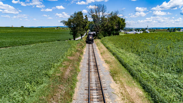 head on drone view of a steam passenger train approaching on a single track - 12023 imagens e fotografias de stock