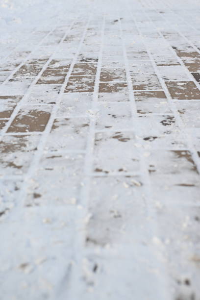 istock snow-covered asphalt, snow-covered road surface asphalt tile covered with thin ice crust, icy ice tile, concrete tile texture on asphalt 1858053027