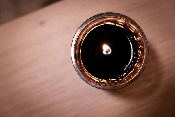 Top view of a burning aromatic candle with yellow flame in the holidays