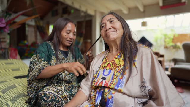 Indigenous mother and daughter taking care of each other