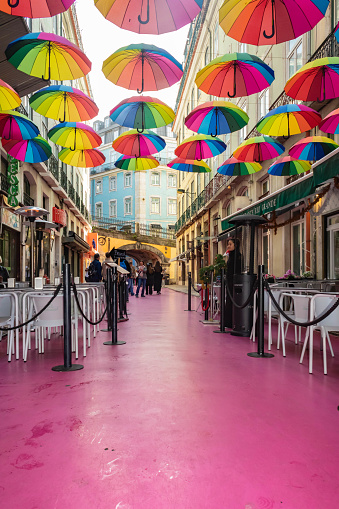 Lisbon, Portugal - November 25th 2023: Famous Pink street with colorful umbrellas in Lisbon