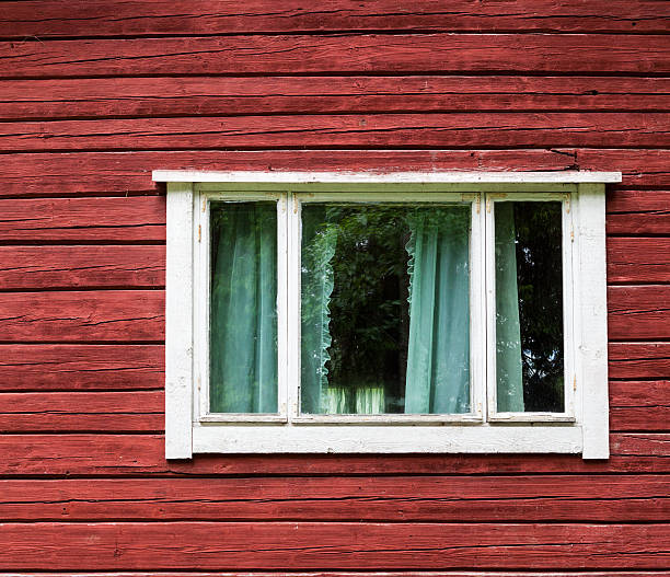 istock Window in a red wooden house 185810309