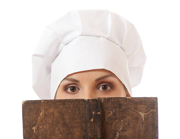 istock woman cook reading recipes book 185810363