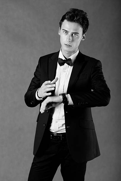 istock Young handsome businessman pointing at watch 185811323