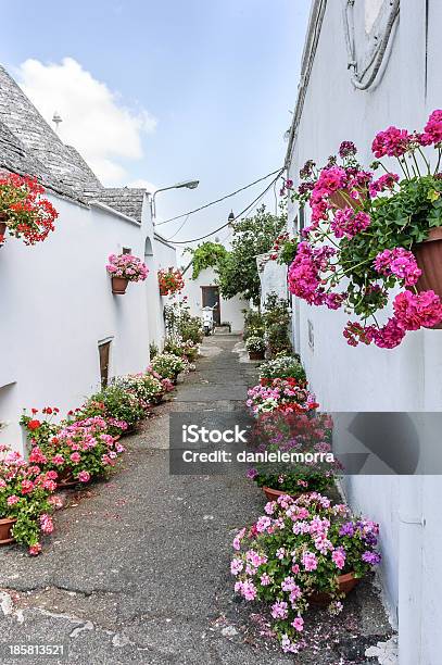 Colorful Flowers In Alberobello Street Stock Photo - Download Image Now - Alberobello, Ancient, Architectural Dome