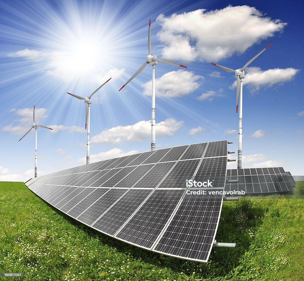 energy concepts solar energy panels and wind turbine Blue Stock Photo