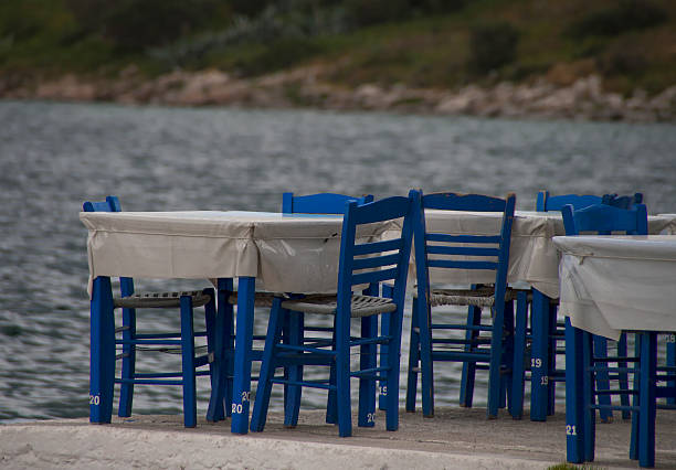 istock Taverna's Tables and blue chairs by the seaside 185818252