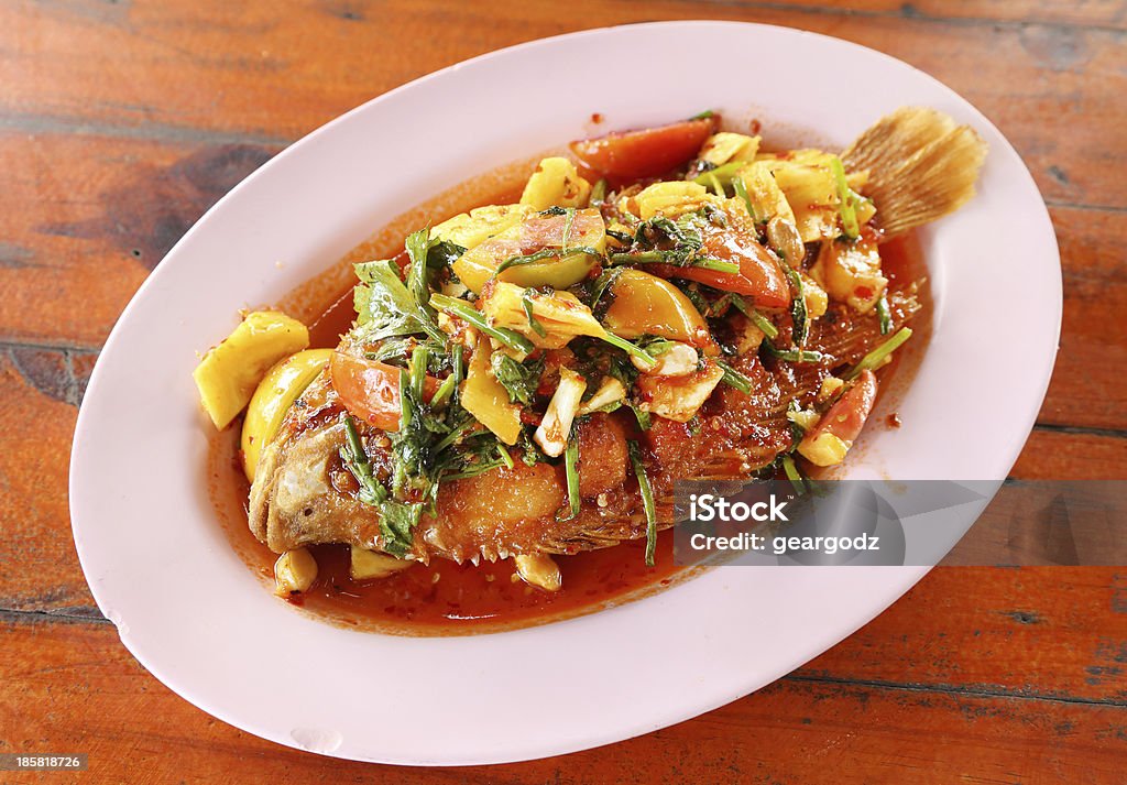 Fried ruby fish topped with sweet,sauer and hot sauce Fried ruby fish topped with sweet,sauer and hot sauce on dish Appetizer Stock Photo