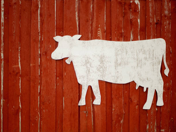 istock Red rustic wooden barn facade
  with cow stencil for text, farming concept 1858197302