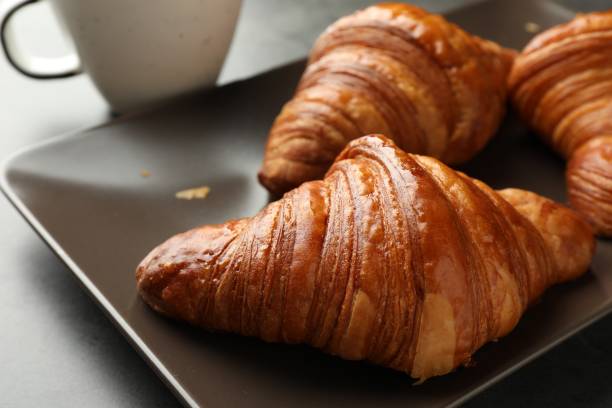istock Delicious fresh croissants on grey table, closeup 1858216378