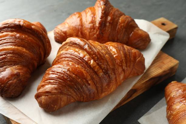istock Delicious fresh croissants on grey table, closeup 1858216896